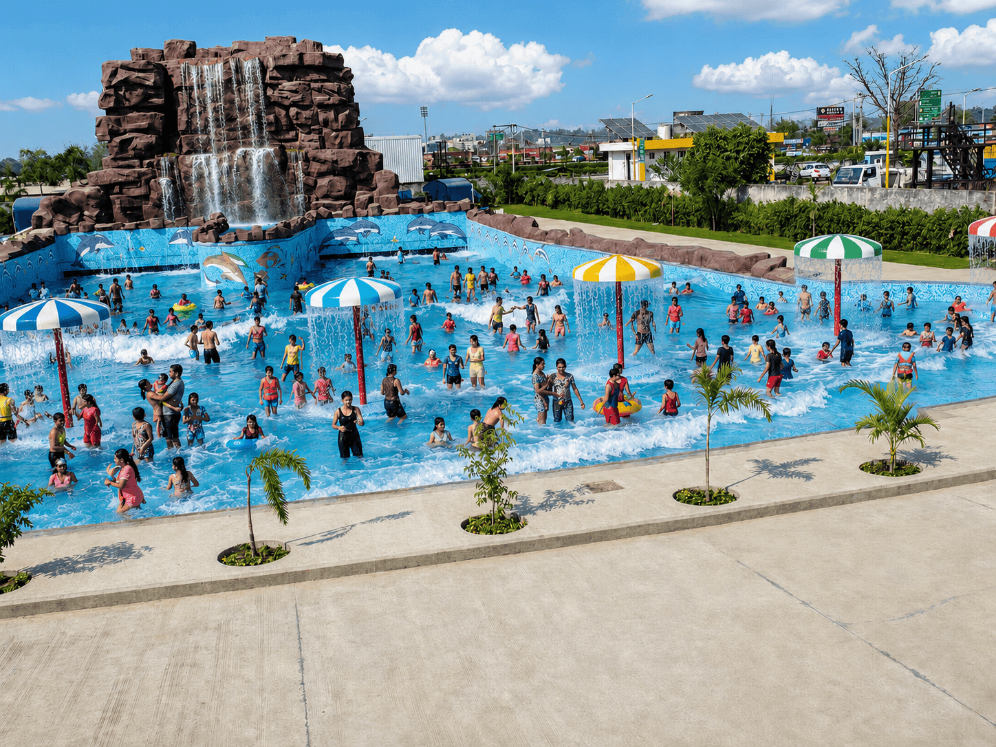 Guests in the wave pool below the rock waterfall at Dolphin Water Resort